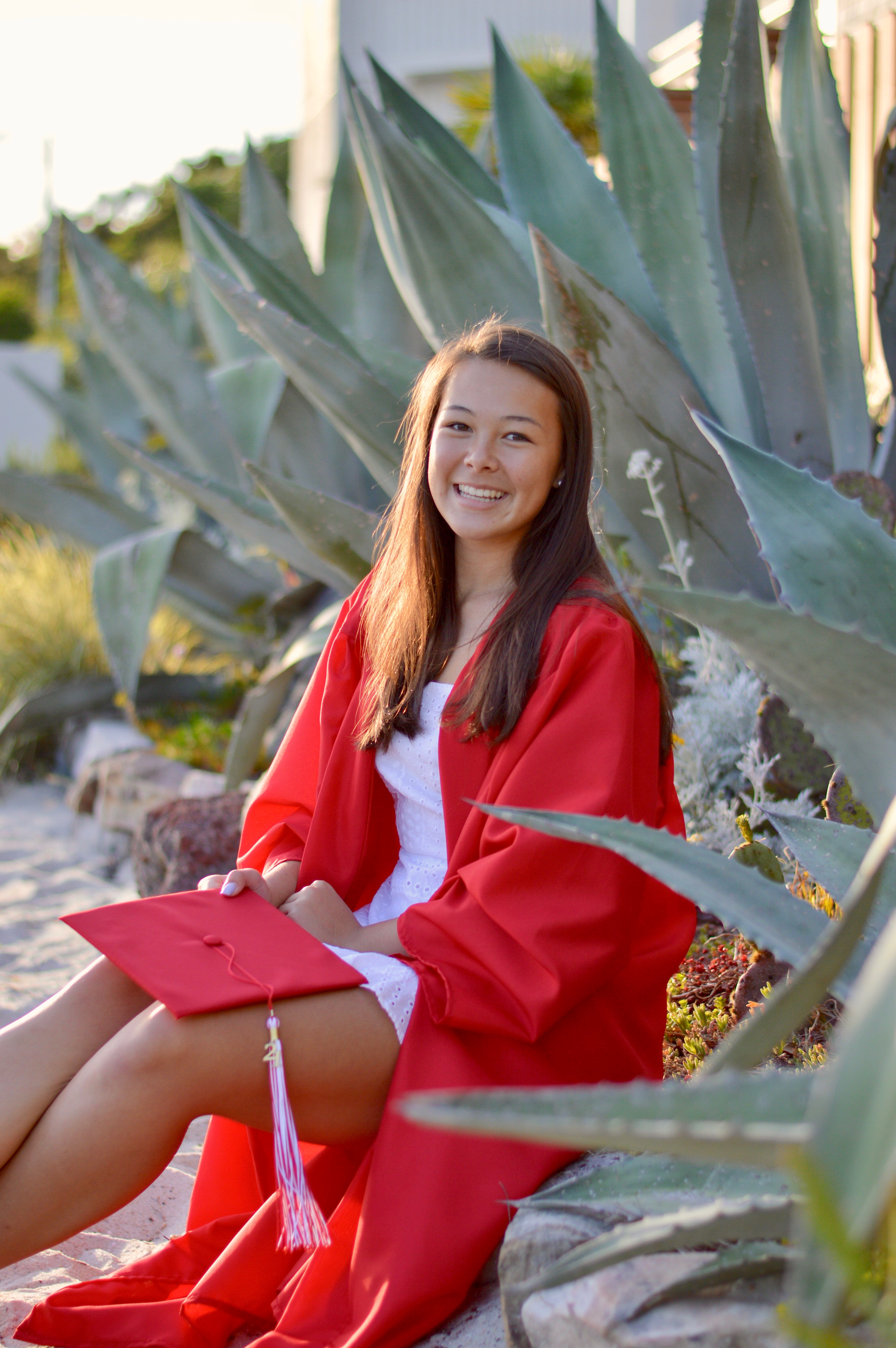 Union Academy graduate, Mya Manivanh, in red graduation gown.