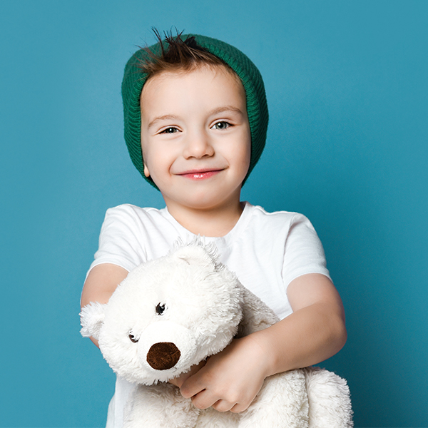 child holding a stuffed polar bear.