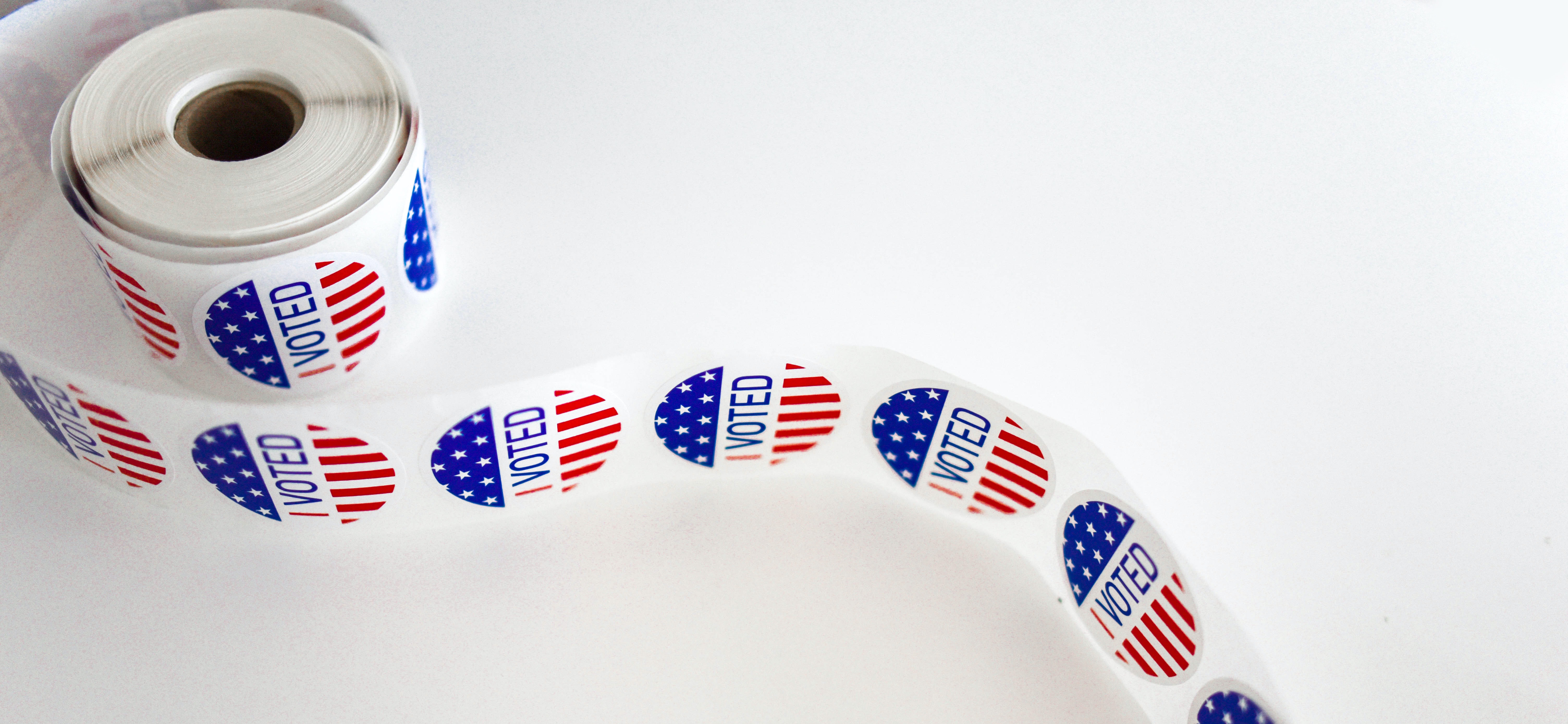 A roll of stickers on a white background. Each sticker says, "I voted."